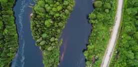 Island in the middle of a river next to a highway