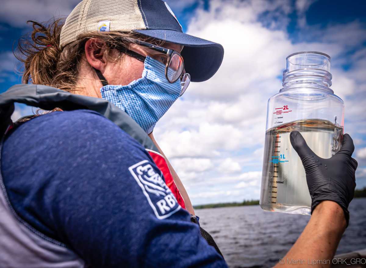 Larissa Holman holding water sample