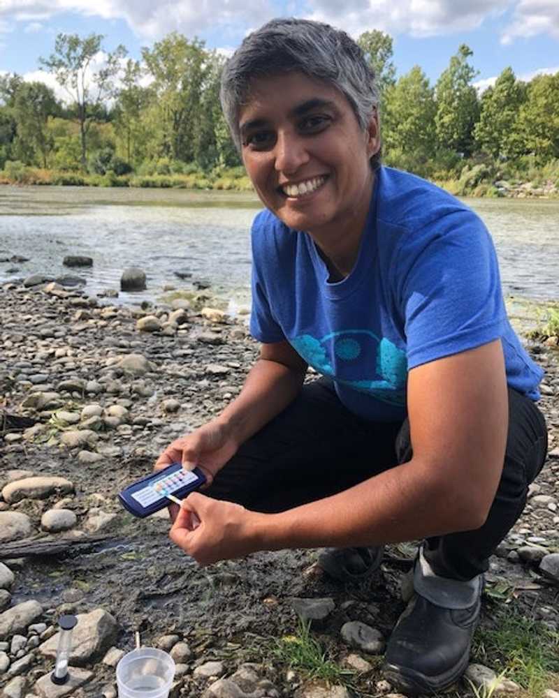 Raj Gill is monitoring for water quality on a rocky shoreline